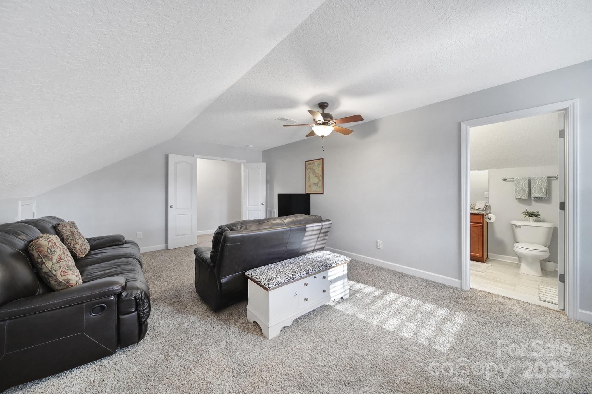 2045 Roadrunner Road Clover, SC 29710 - Photo 24 of 38 a living room with furniture and a chandelier