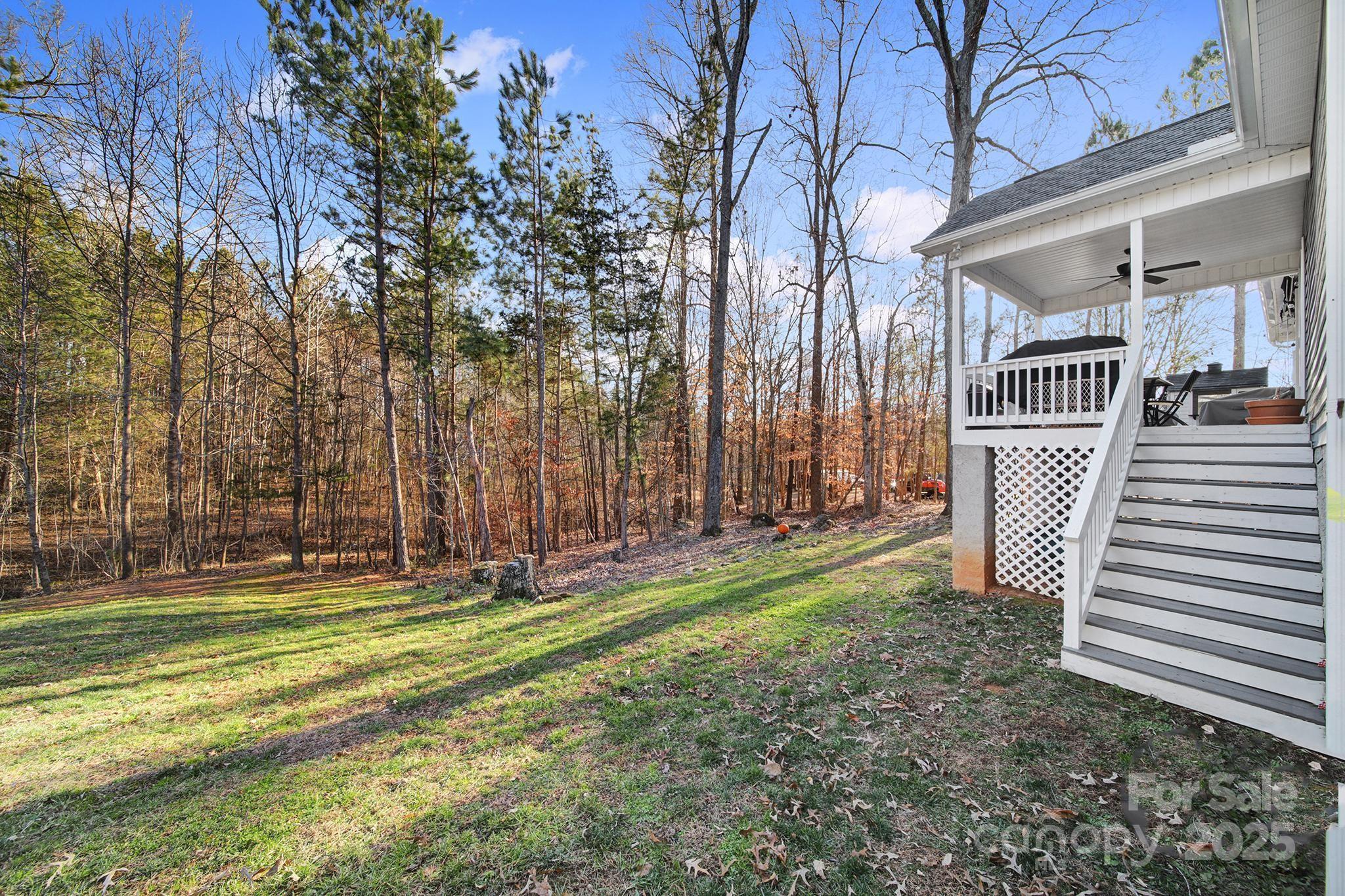 2045 Roadrunner Road Clover, SC 29710 - Photo 27 of 38 a backyard of a house with lots of green space and trees