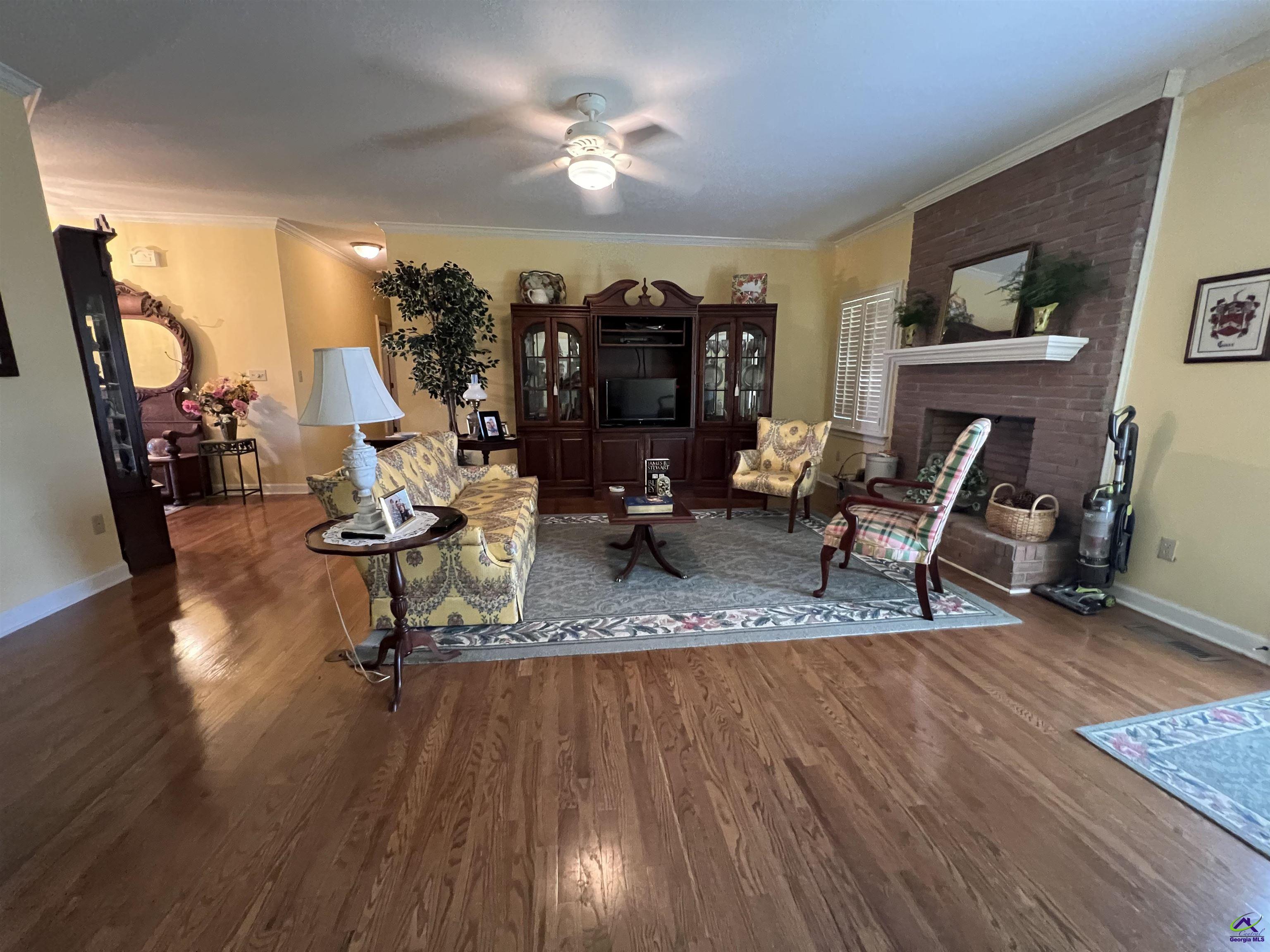 762 Nicholson-Carr Road Chester, GA 31012 - Photo 7 of 81 a living room filled with furniture and a chandelier