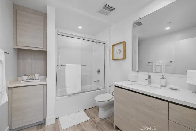 a spacious bathroom with a sink a toilet and shower