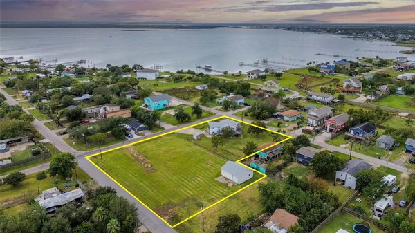 a view of a tennis ground with a small pool