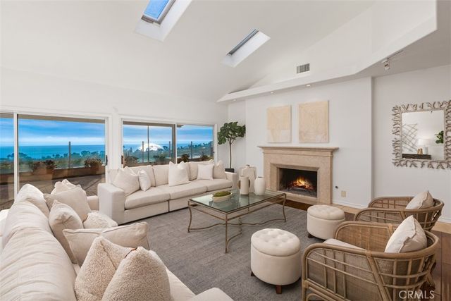 a living room with furniture a fireplace and a large window