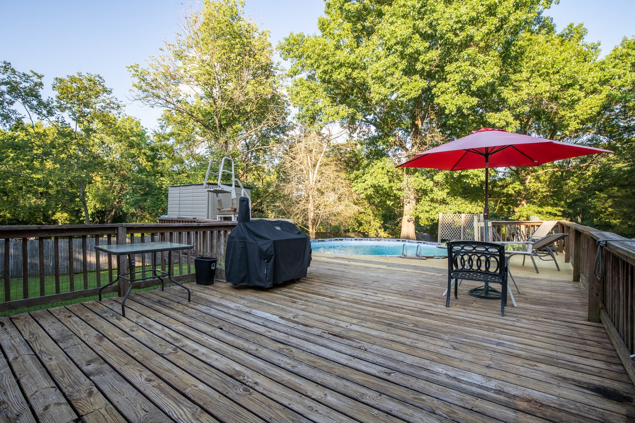 109 Randy Road Madison, TN 37115 - Photo 22 of 31 a view of a roof deck with table and chairs under an umbrella with wooden floor