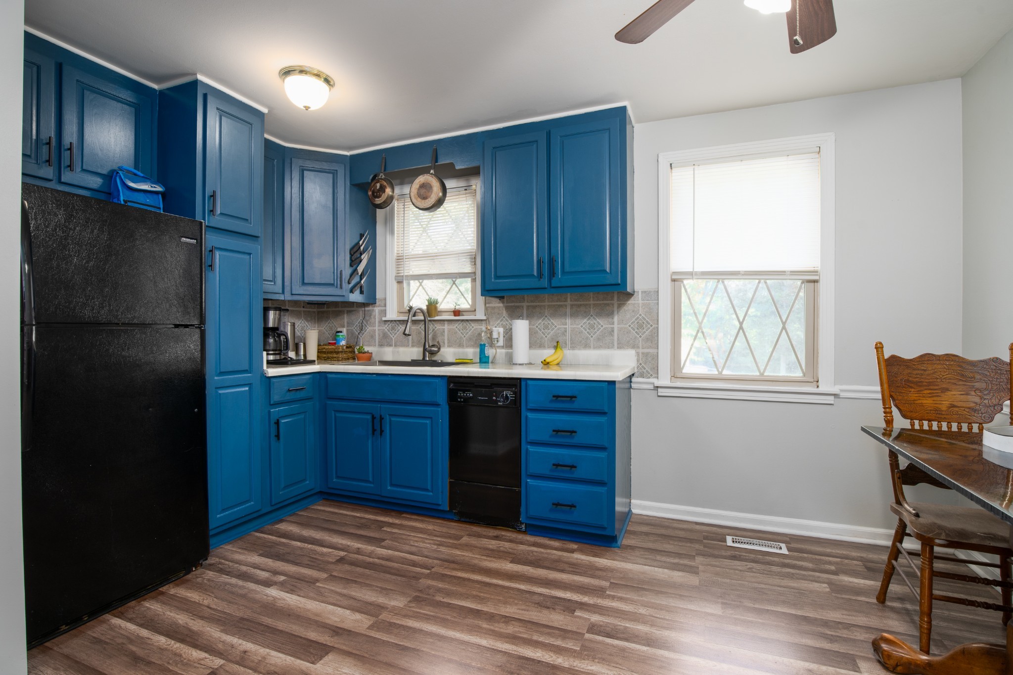 109 Randy Road Madison, TN 37115 - Photo 7 of 31 a kitchen with wooden floors and wooden cabinets
