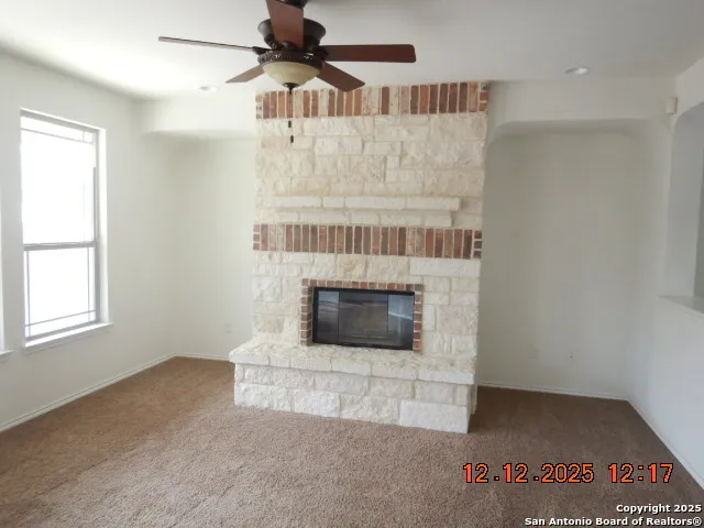 a view of an empty room with a fireplace