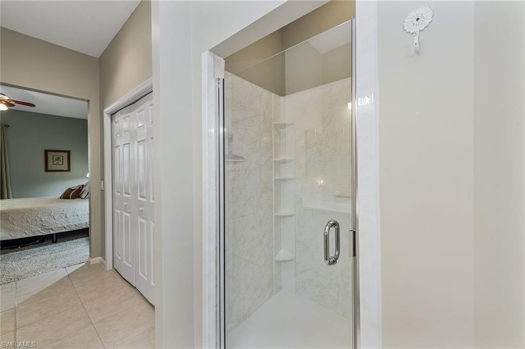 3945 Deer Crossing Court, Unit 203 Naples, FL 34114 - Photo 15 of 50 a en suite bathroom with a shower