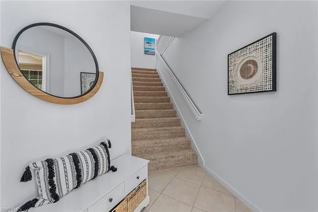 a view of a livingroom with furniture and staircase