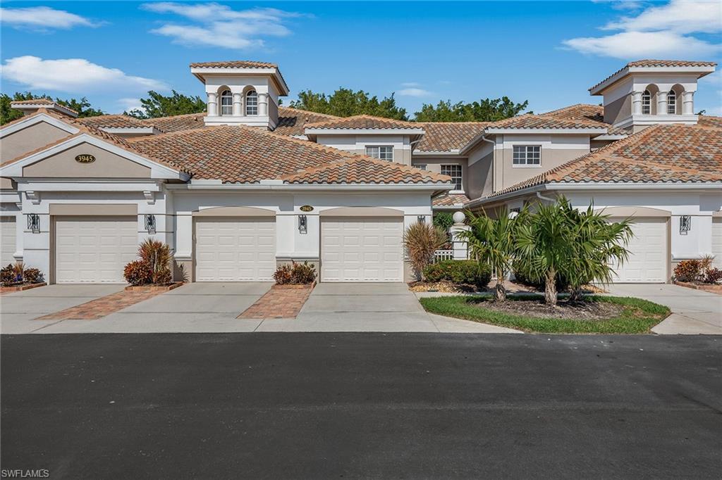 3945 Deer Crossing Court, Unit 203 Naples, FL 34114 - Photo 27 of 50 a front view of a house with a yard