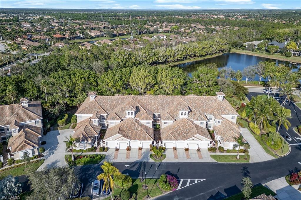 3945 Deer Crossing Court, Unit 203 Naples, FL 34114 - Photo 28 of 50 an aerial view of residential houses with outdoor space and river