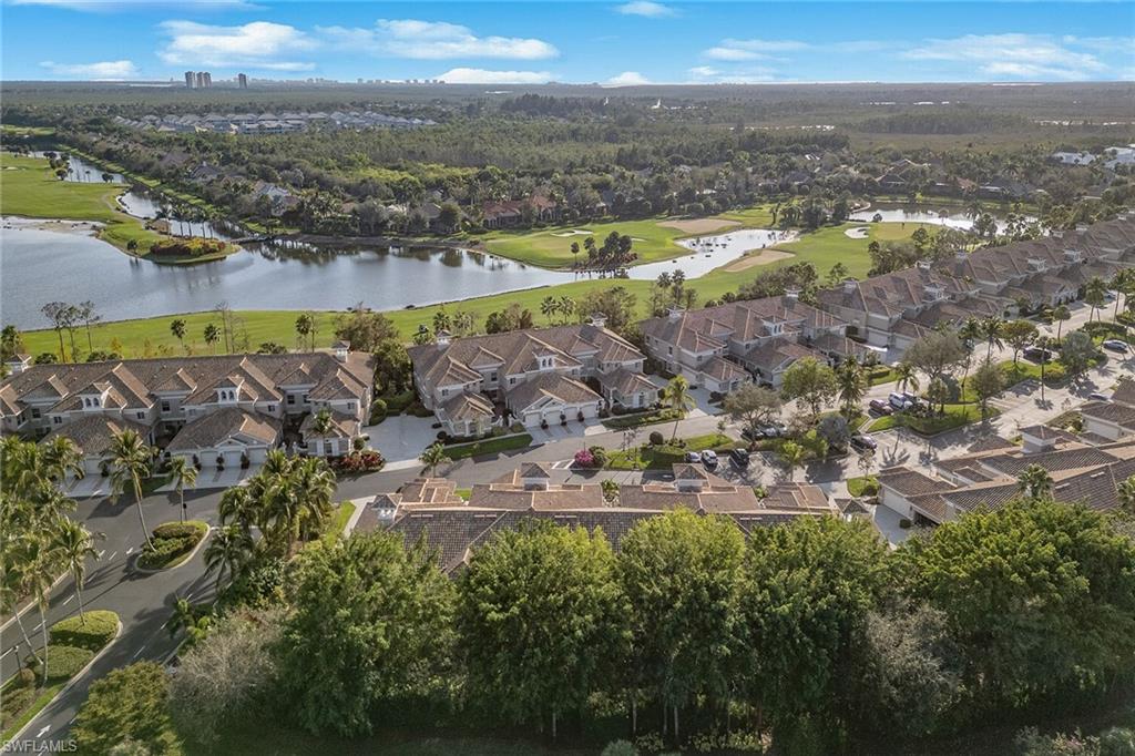 3945 Deer Crossing Court, Unit 203 Naples, FL 34114 - Photo 30 of 50 an aerial view of residential building and lake