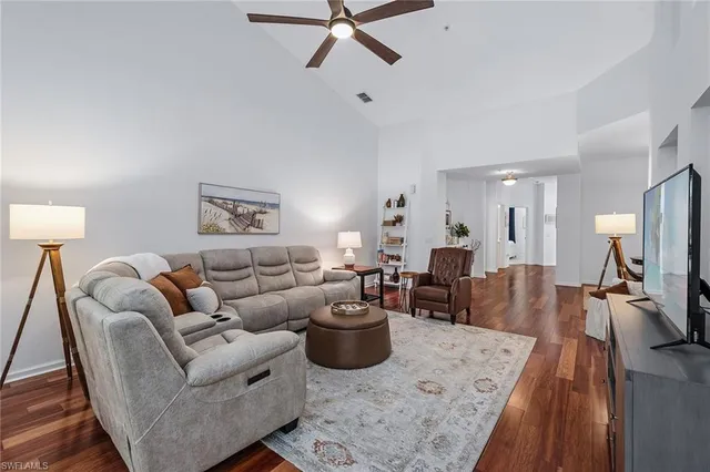 a living room with furniture a couch and a flat screen tv