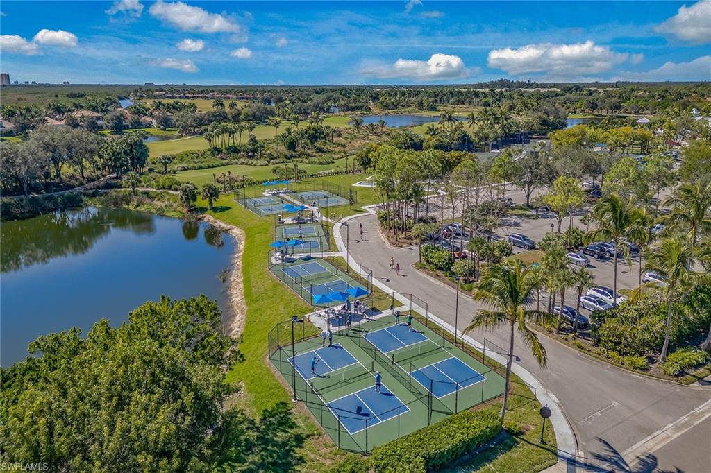 3945 Deer Crossing Court, Unit 203 Naples, FL 34114 - Photo 45 of 50 an aerial view of residential houses with outdoor space and lake view