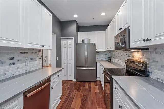 a kitchen with granite countertop stainless steel appliances and wooden cabinets
