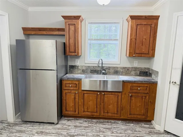 a kitchen with stainless steel appliances granite countertop a refrigerator and a sink