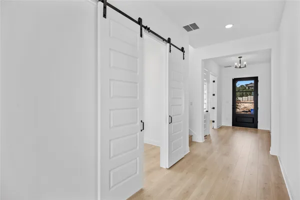 a bathroom with a tub a sink and mirror