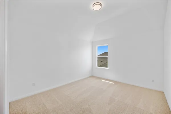 an empty room with a window and ceiling fan