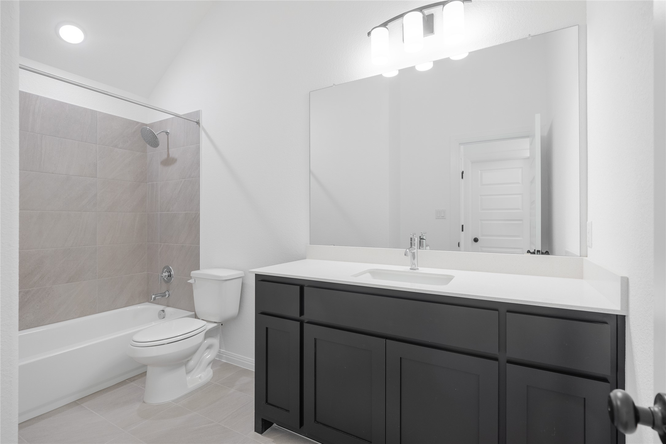 3213 Lookout Mountain Road Georgetown, TX 78628 - Photo 24 of 40 Bathroom with bathtub / shower combination, vanity, and light tile patterned floors
