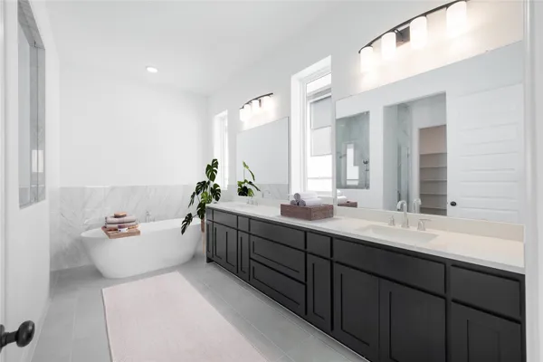 a bathroom with a double vanity sink and mirror