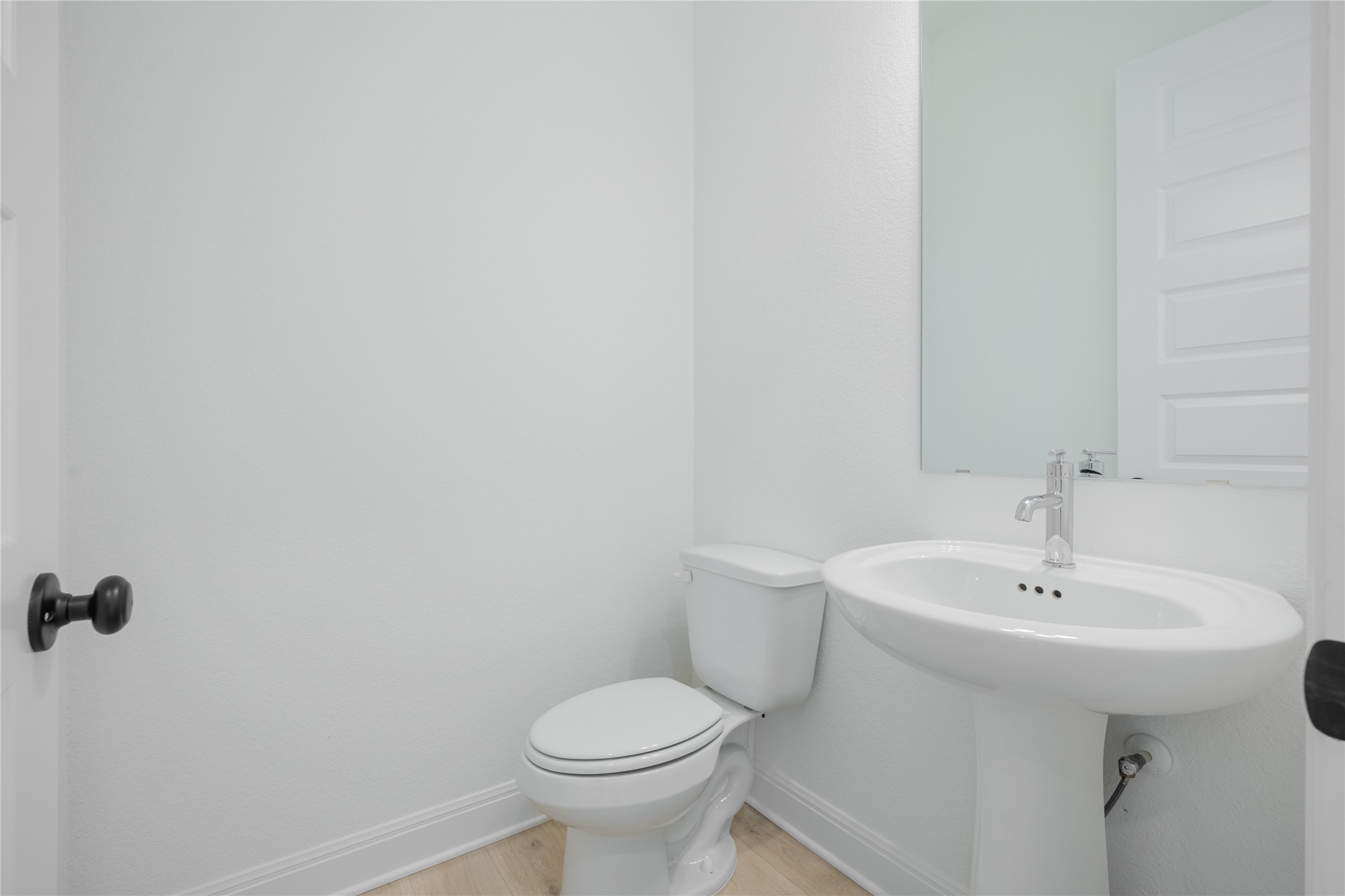 3213 Lookout Mountain Road Georgetown, TX 78628 - Photo 31 of 40 Powder Bathroom featuring baseboards and light wood-style flooring