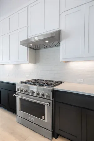 a kitchen with white cabinets and a sink