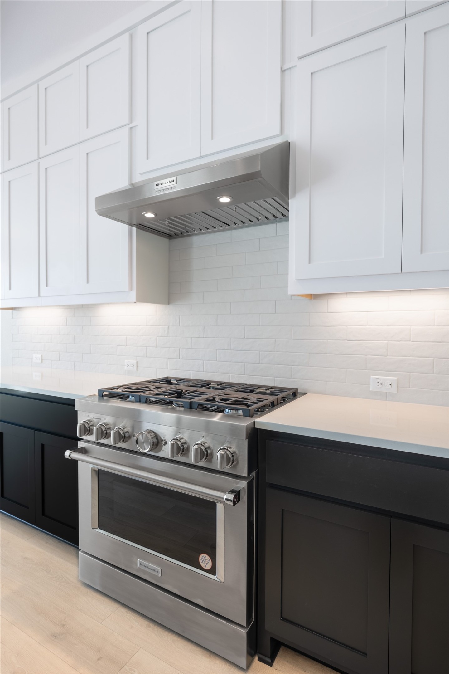 3213 Lookout Mountain Road Georgetown, TX 78628 - Photo 32 of 40 Dual tone kitchen featuring dual tone cabinets, stainless steel range, tasteful backsplash, and light stone counters