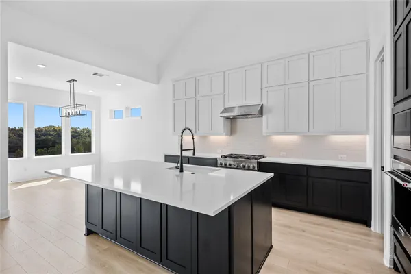 a kitchen with a sink cabinets and window
