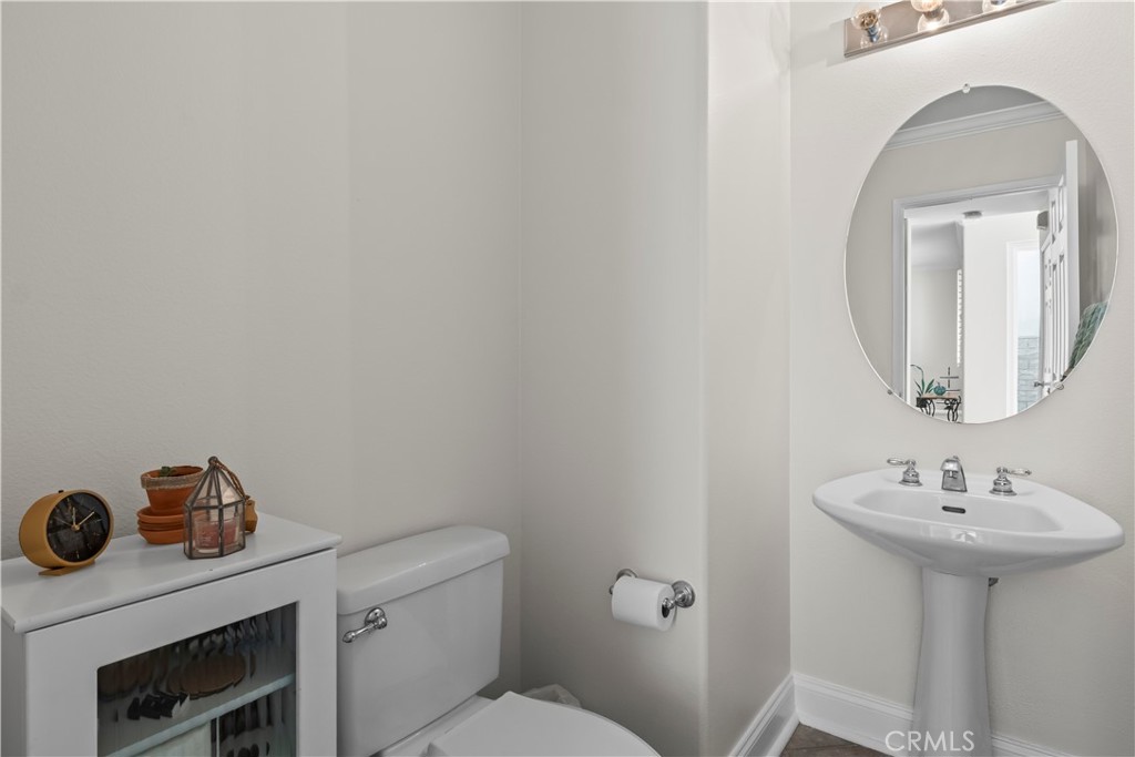 27 Rolling Ridge Rancho Santa Margarita, CA 92688 - Photo 15 of 42 a bathroom with a sink mirror and toilet