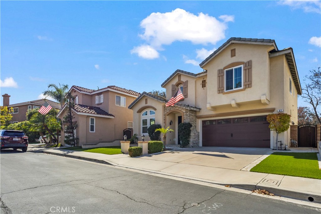 27 Rolling Ridge Rancho Santa Margarita, CA 92688 - Photo 2 of 42 a front view of a house with a yard and garage