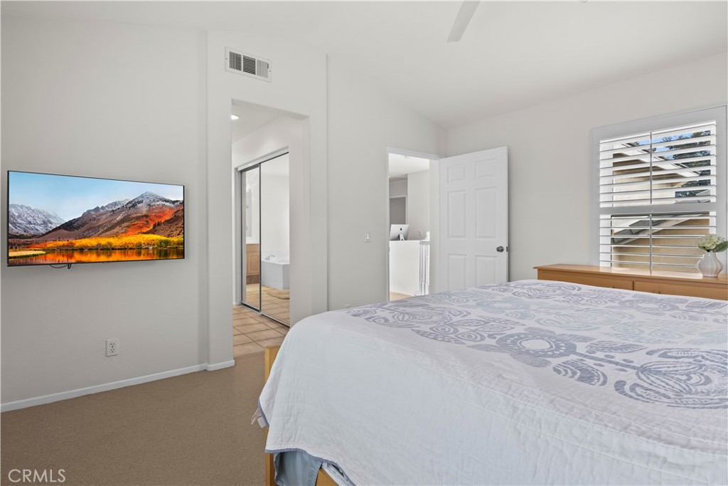 27 Rolling Ridge Rancho Santa Margarita, CA 92688 - Photo 22 of 42 a bedroom with a bed and a painting on the wall