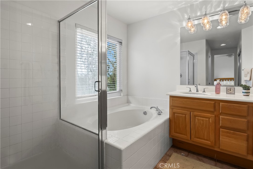 27 Rolling Ridge Rancho Santa Margarita, CA 92688 - Photo 23 of 42 a bathroom with a tub sink and mirror
