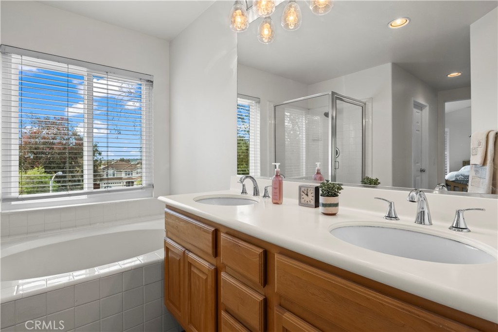 27 Rolling Ridge Rancho Santa Margarita, CA 92688 - Photo 24 of 42 a bathroom with a granite countertop sink and a bathtub