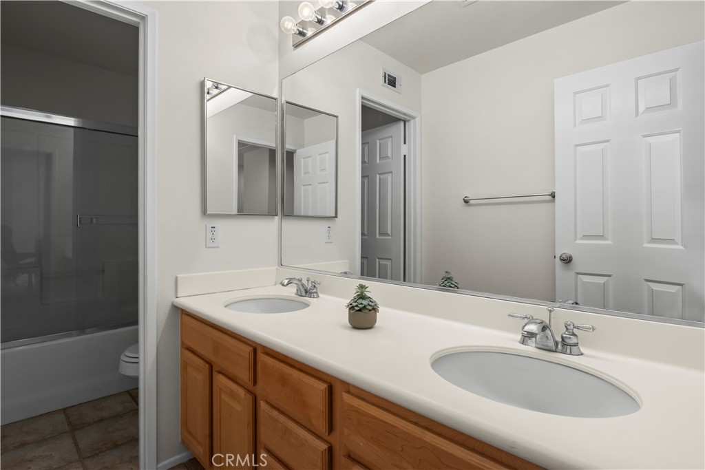 27 Rolling Ridge Rancho Santa Margarita, CA 92688 - Photo 28 of 42 a bathroom with double vanity sinks and a mirror