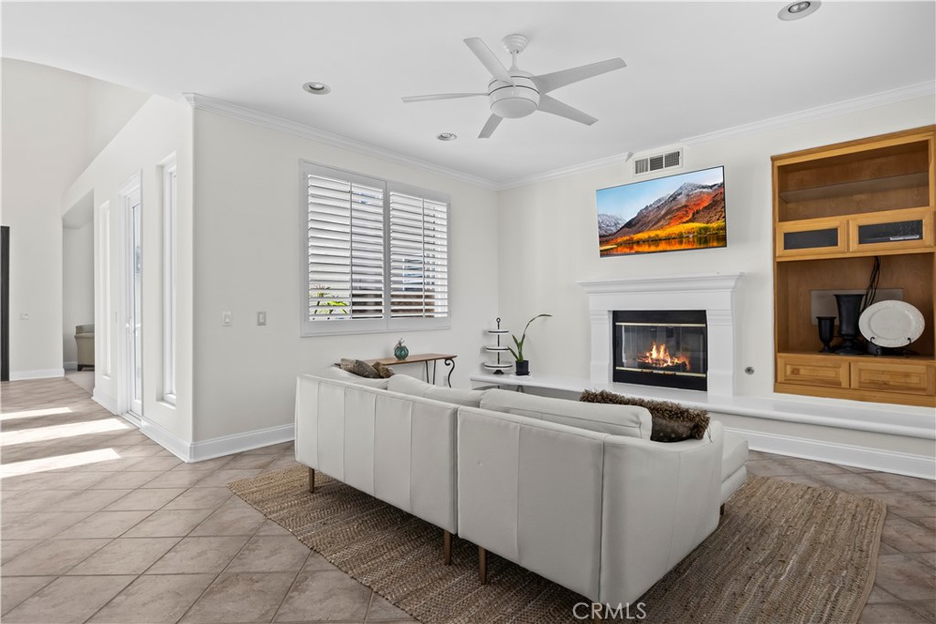 27 Rolling Ridge Rancho Santa Margarita, CA 92688 - Photo 7 of 42 a view of an empty room with a fireplace and a window
