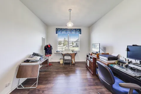 a view of a workspace with furniture and a window