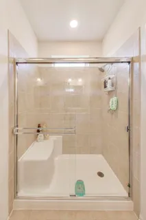 a bathroom with a shower and a bath tub