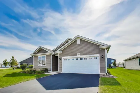 a view of a house with a yard and garage