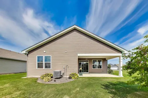 a front view of a house with a garden and yard
