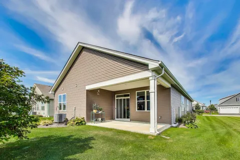a front view of house with a garden