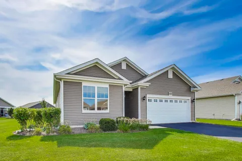 a view of a house with a yard and plants