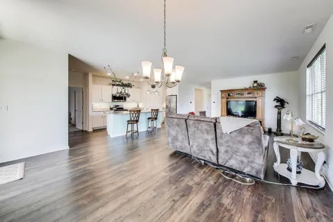 a living room with fireplace furniture and a wooden floor