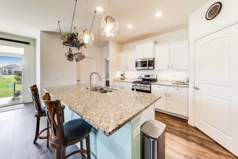 a kitchen with a table chairs and a refrigerator