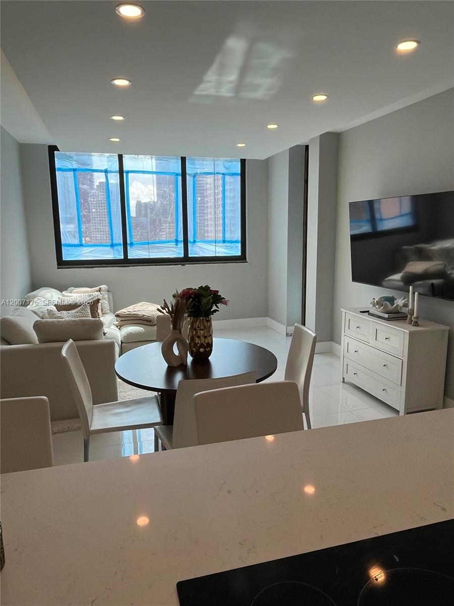540 Brickell Key Drive, Unit 1809 Miami, FL 33131 - Photo 14 of 25 a living room with furniture and a flat screen tv
