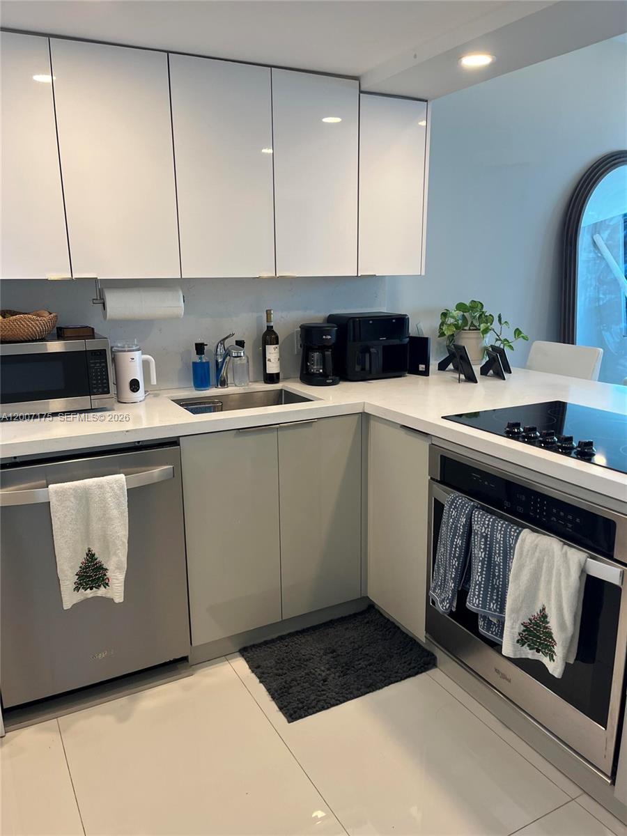 540 Brickell Key Drive, Unit 1809 Miami, FL 33131 - Photo 15 of 25 a kitchen with a sink cabinets and appliances