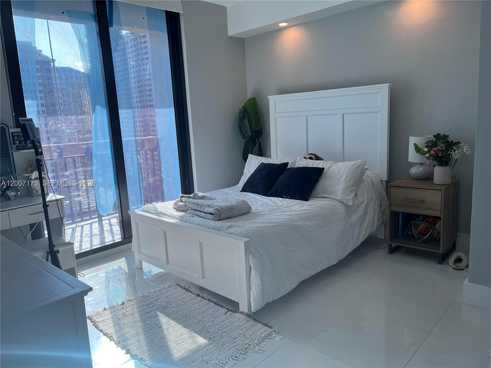 540 Brickell Key Drive, Unit 1809 Miami, FL 33131 - Photo 16 of 25 a bedroom with a bed and a fireplace