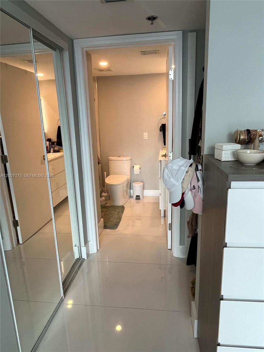 540 Brickell Key Drive, Unit 1809 Miami, FL 33131 - Photo 19 of 25 a view of living room with furniture and a mirror