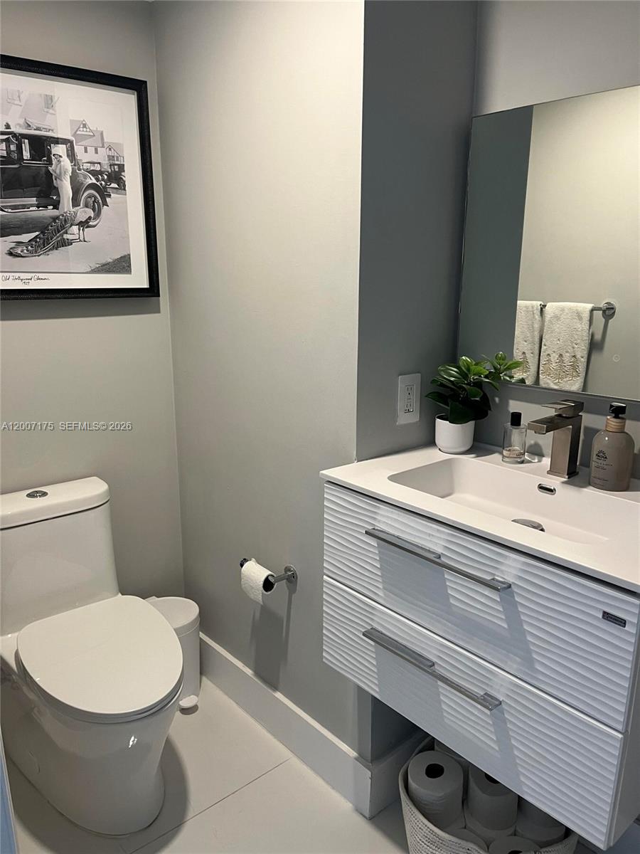 540 Brickell Key Drive, Unit 1809 Miami, FL 33131 - Photo 21 of 25 a bathroom with a sink and a toilet