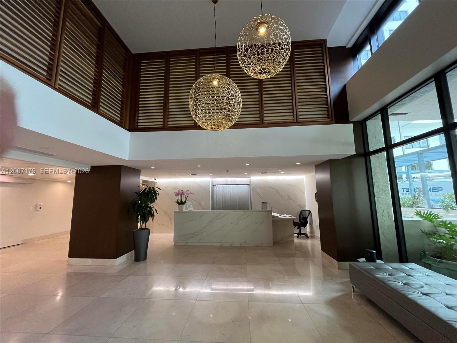 540 Brickell Key Drive, Unit 1809 Miami, FL 33131 - Photo 7 of 25 a view of a hallway with chandelier