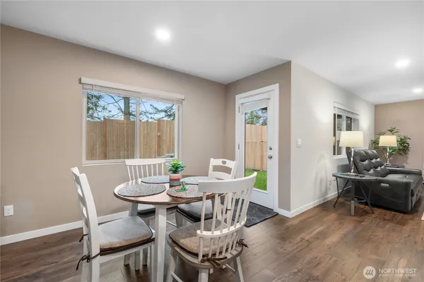 a view of a dining room with furniture and wooden floor
