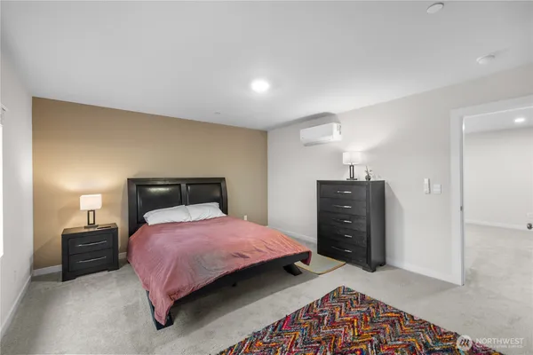 a bedroom with a bed and dresser