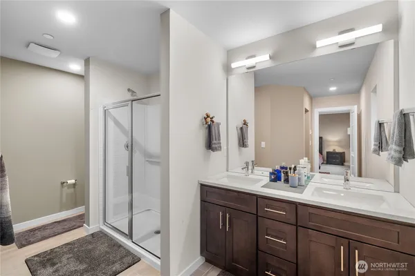 a bathroom with a shower sink and mirror